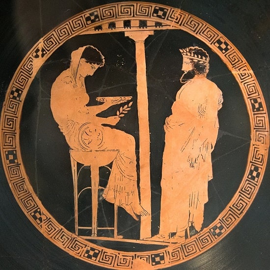 Cílice de figuras rojas en la que se observa la consulta del mítico rey ateniense Egeo a la Pitia délfica, última que permanece sentada sobre su trípode mientras sujeta una rama de laurel